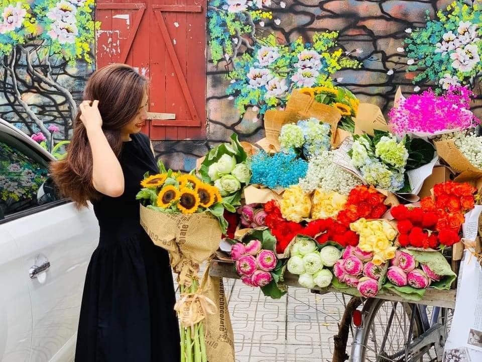 Young people in trend of check-in with flower bike on the streets
