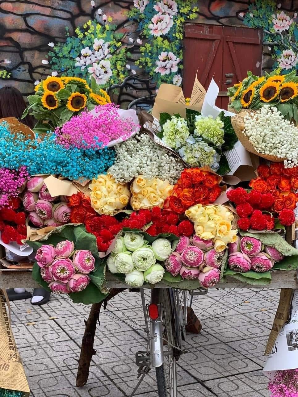 Young people in trend of check-in with flower bike on the streets